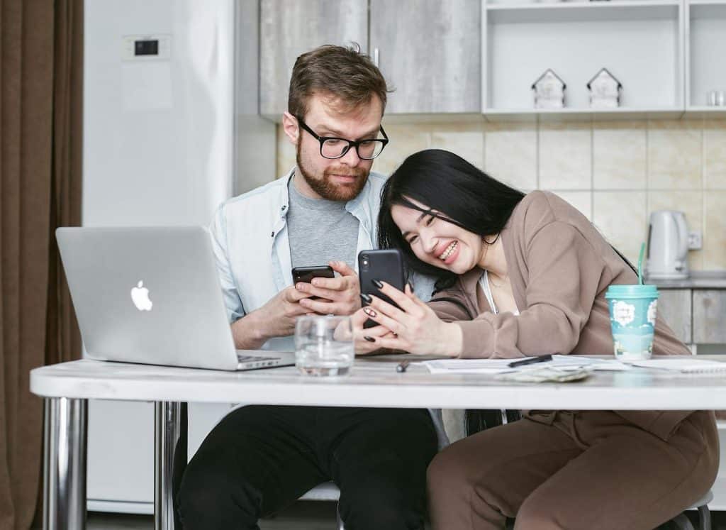 A woman showing something to a man