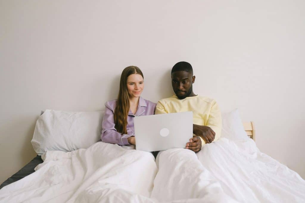 A man and woman using a laptop