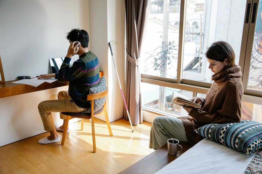 A man working and a woman reading a book