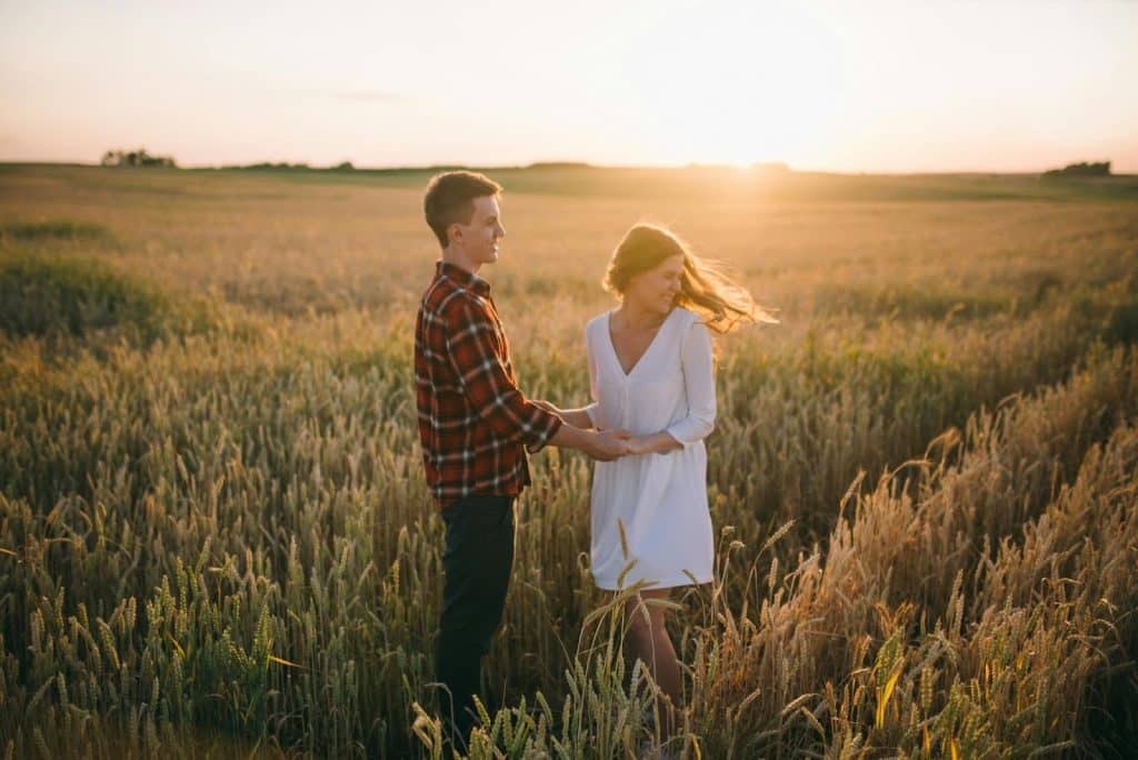 A man holding a woman’s hand