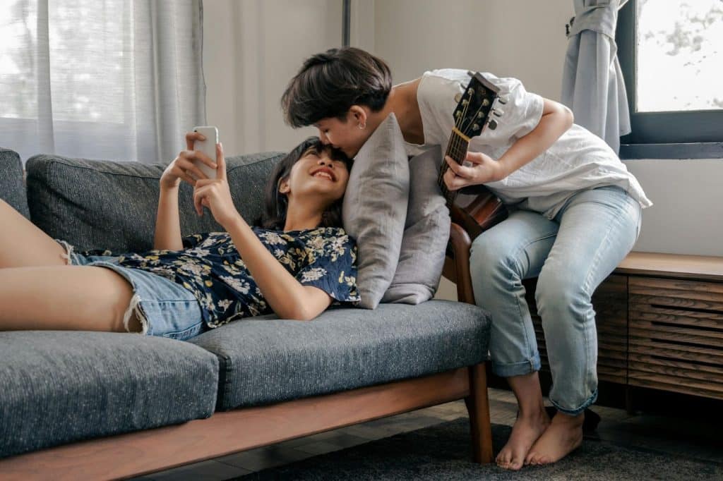 A man kissing a woman’s head