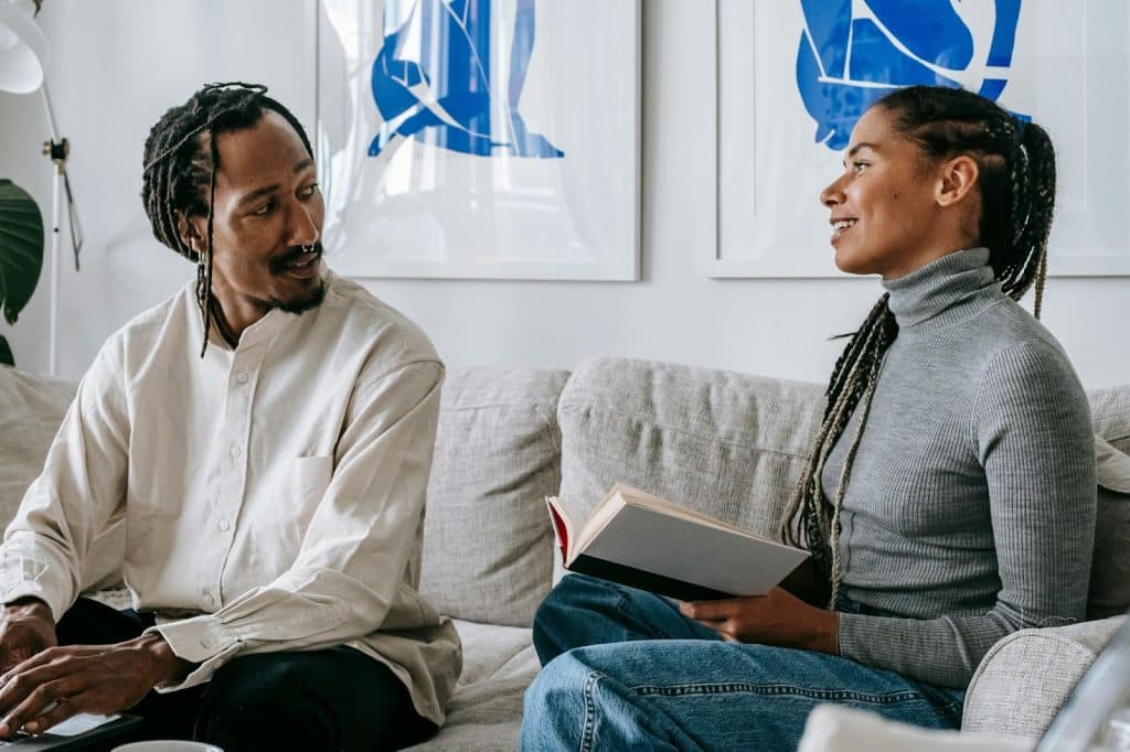Couple chatting while sitting at the couch