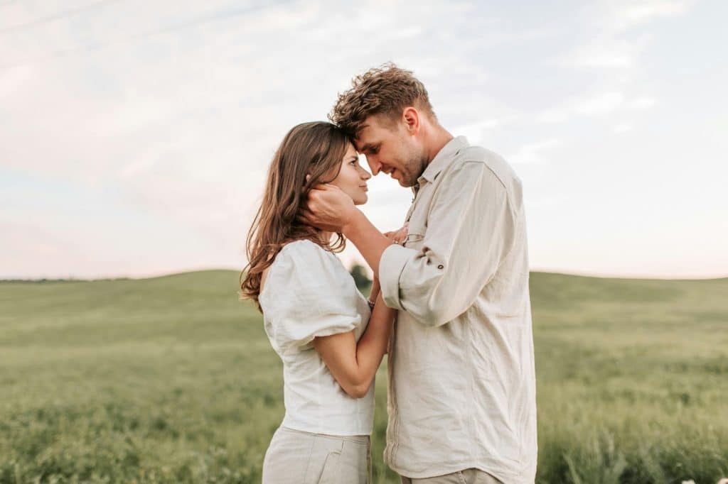 A man holding woman’s face