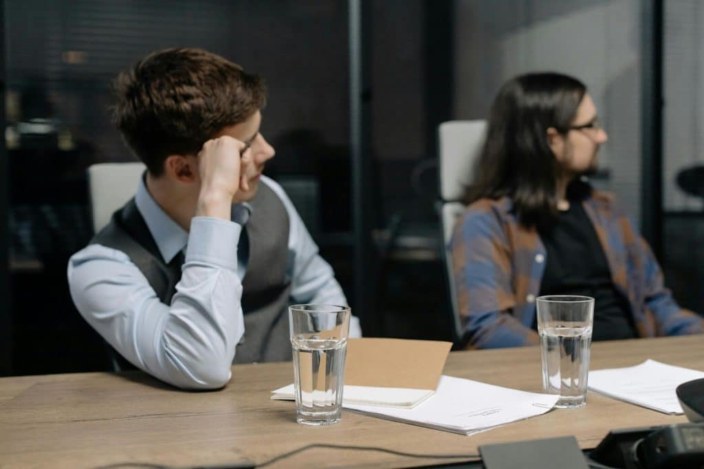 Two men looking tired while at the meeting