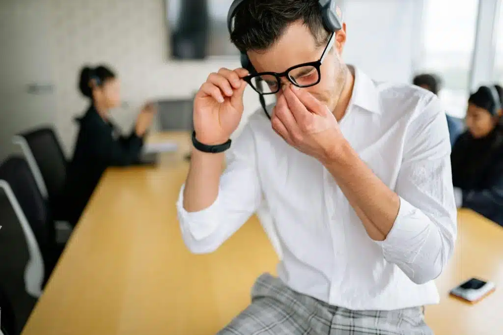 A man holding his nose