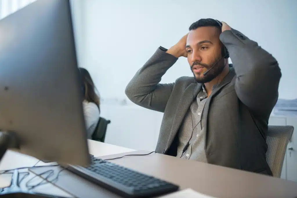 A man looking stressed with his work