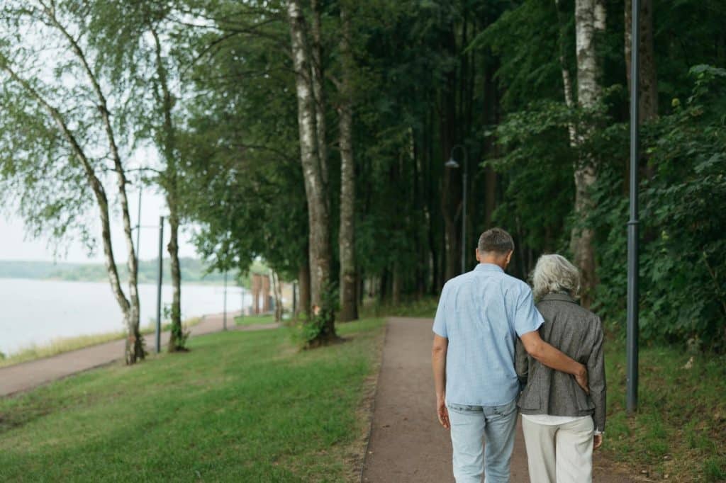 A man and woman walking at the park