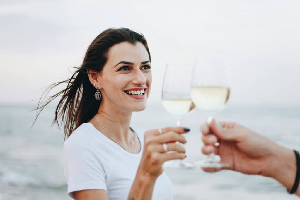 The couple is enjoying a drink on the beach.