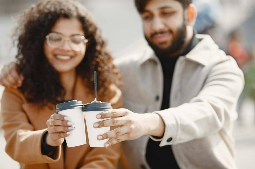 A man and woman having a cup of coffee