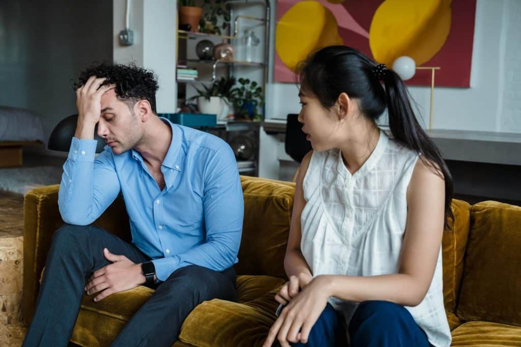 A woman apologizing to man