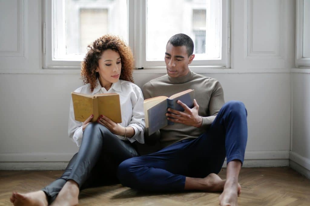 A man and woman reading a book