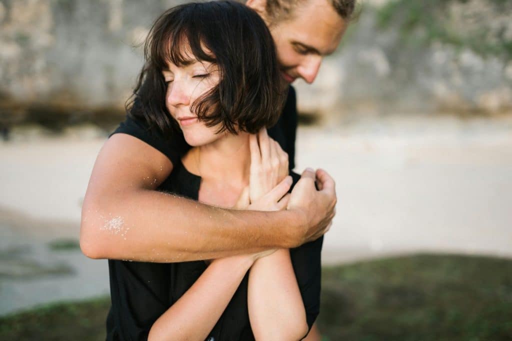 A man hugging a woman