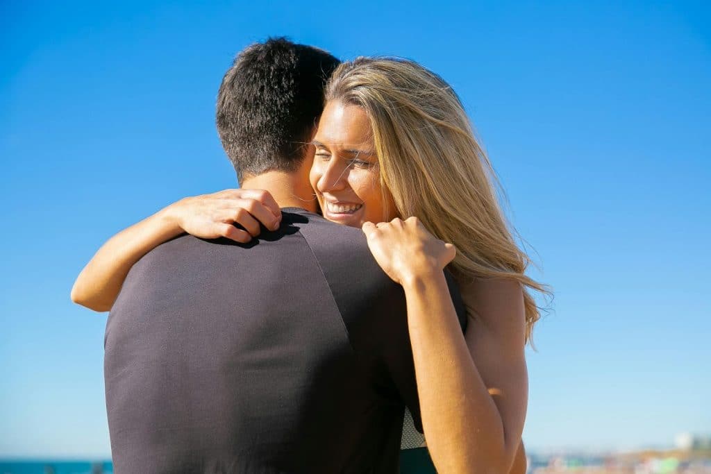 A man and woman hugging each other