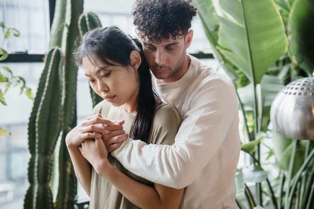 A man hugging a woman