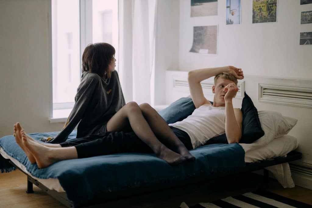 A man and woman at the bed