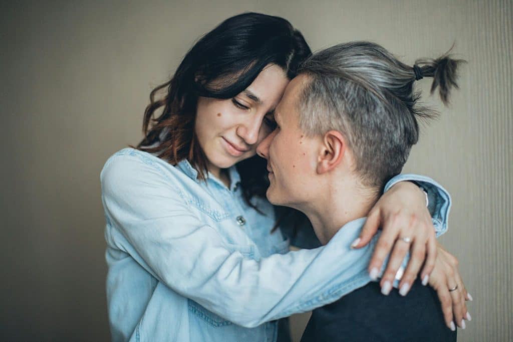 A woman hugging a man