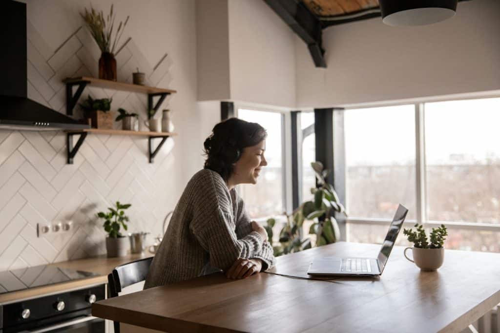 A woman using a laptop for a videocall