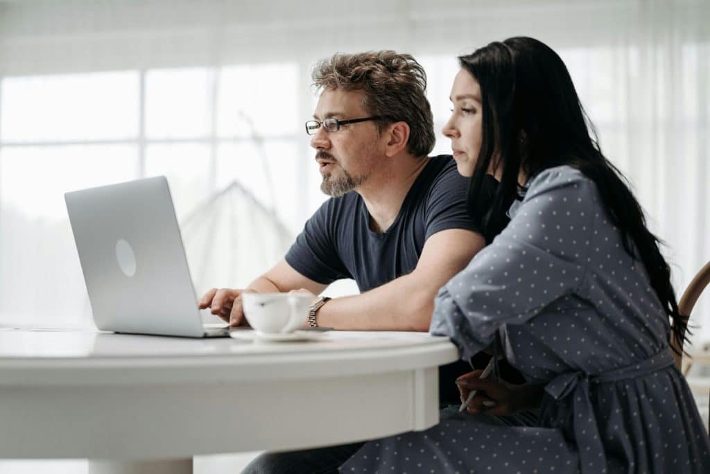 A man and woman using a laptop