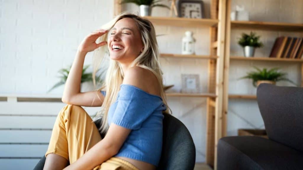 A woman laughing freely during a conversation