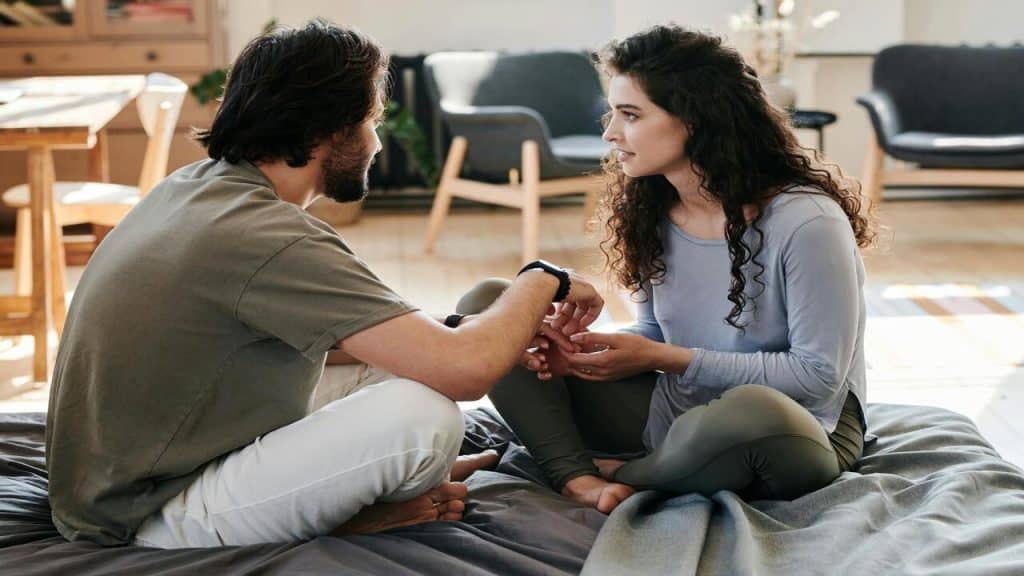 A couple talking at home.