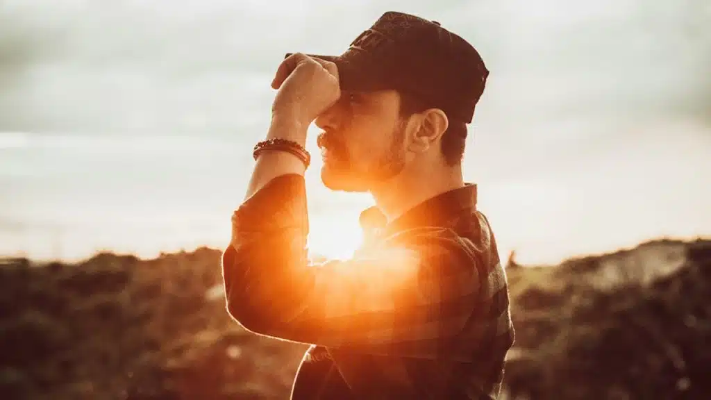 A man standing outdoors in sunset.