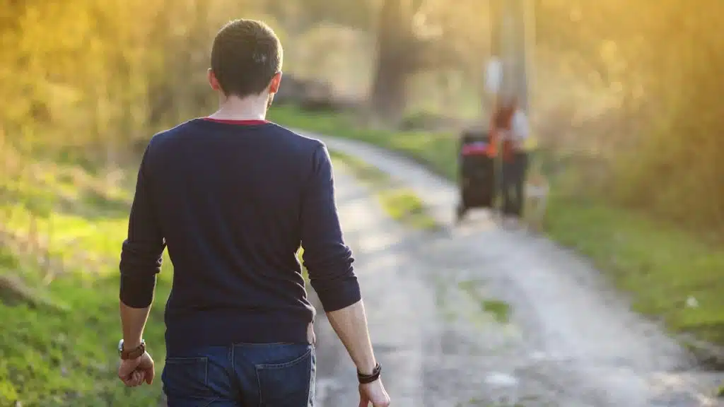 A Man walking down a path in the morning.