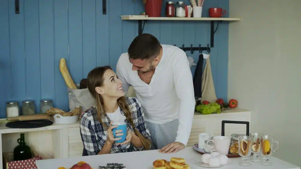 A couple sharing a morning moment in the kitchen.