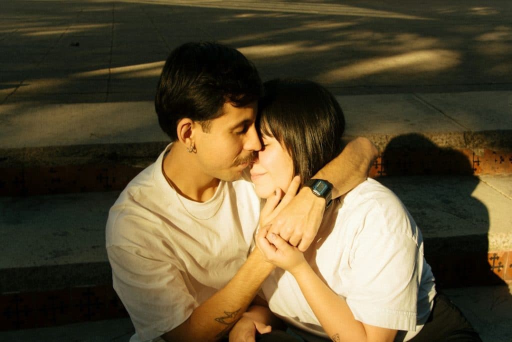 A couple is embracing affectionately and sharing a moment.