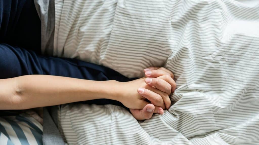 Closeup of a couple holding hands.