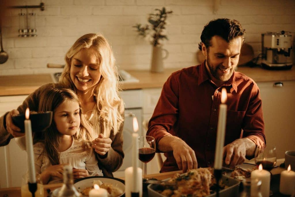 The young family is having dinner.