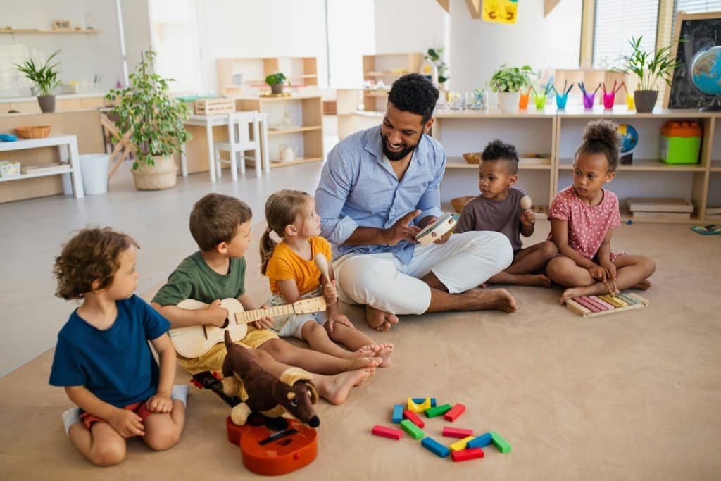 A man talking with some kids and having fun.