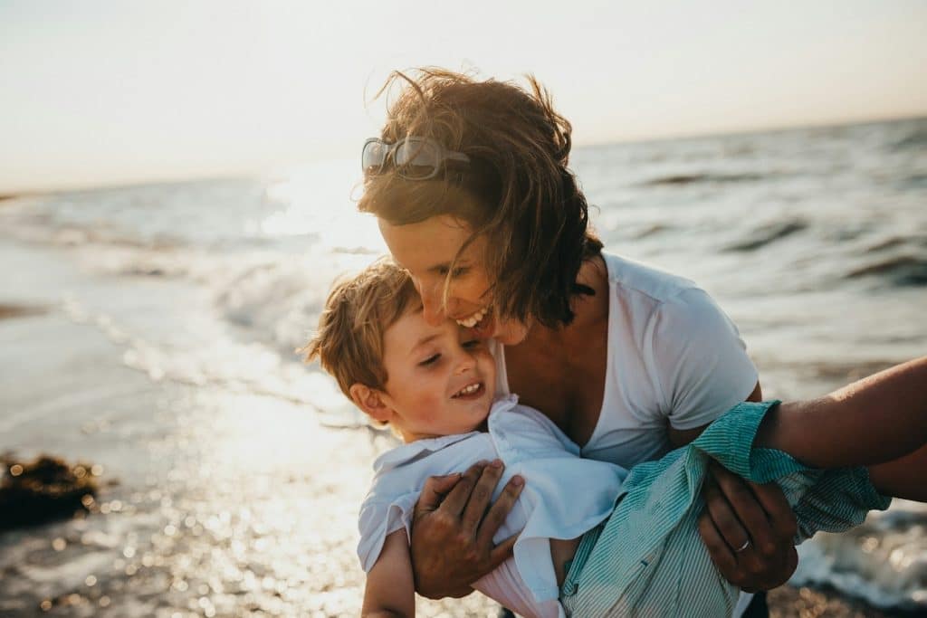 A woman carrying a child and having fun.