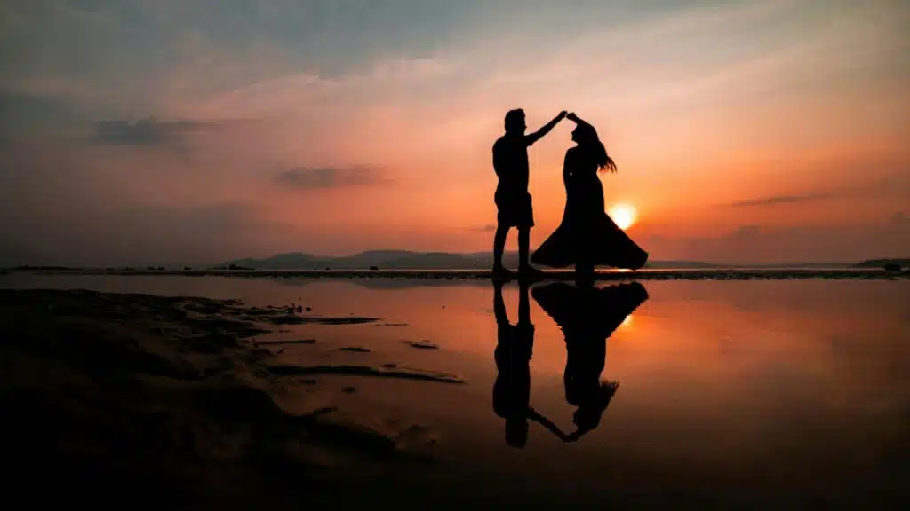 Silhouette of a couple dancing on the beach.