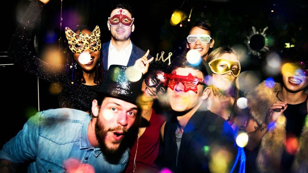 A group of people enjoying a masquerade party.