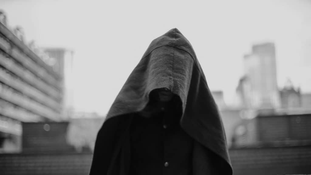A person covered with a blanket.