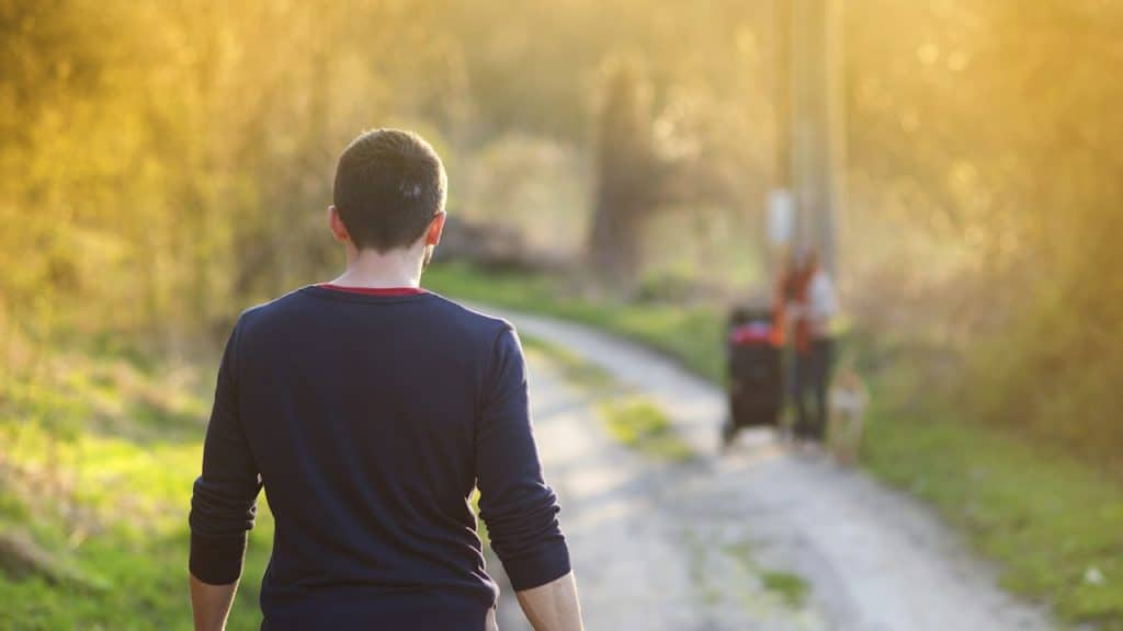 A man walking towards his partner.
