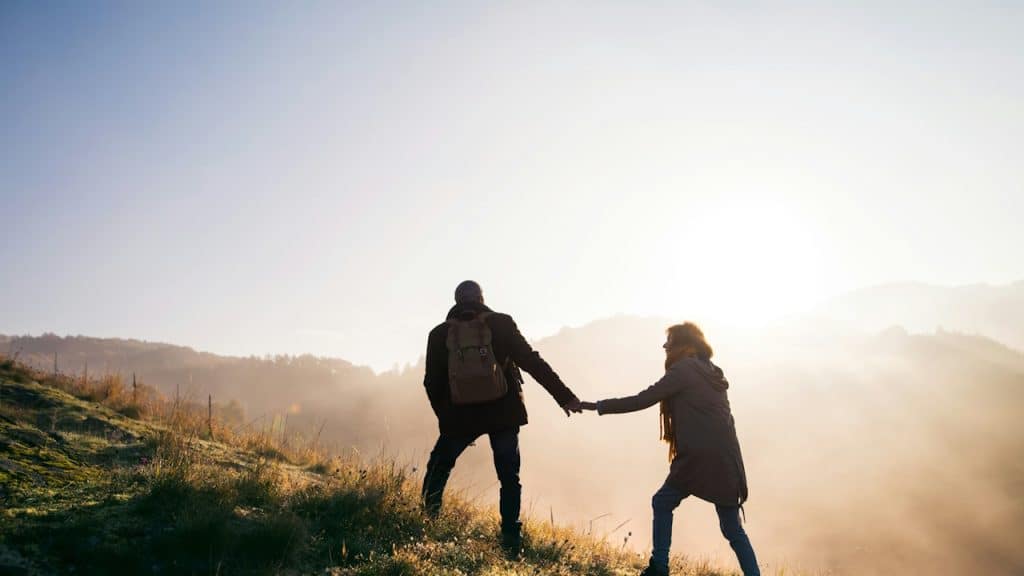 A woman trying to hold the hand of her partner.