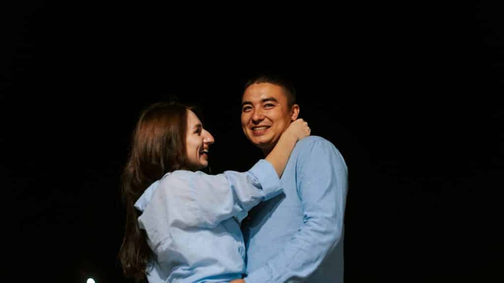 A man and a woman hugging each other.