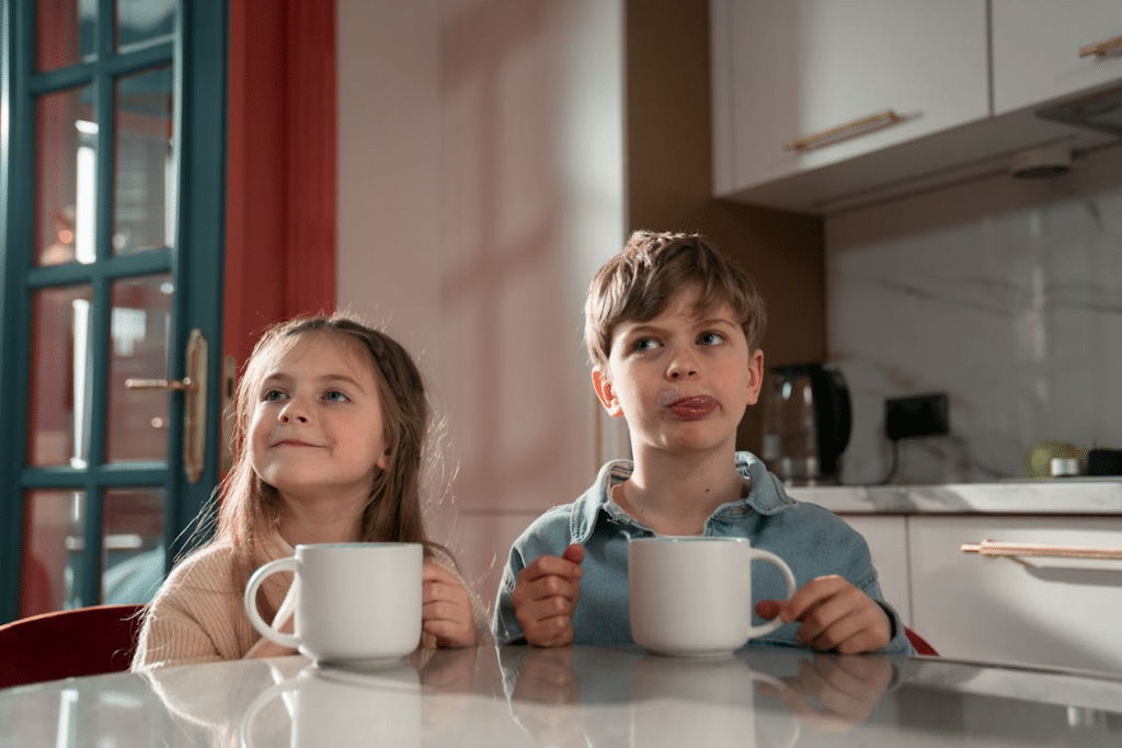 Girl and Boy Sitting at the Table