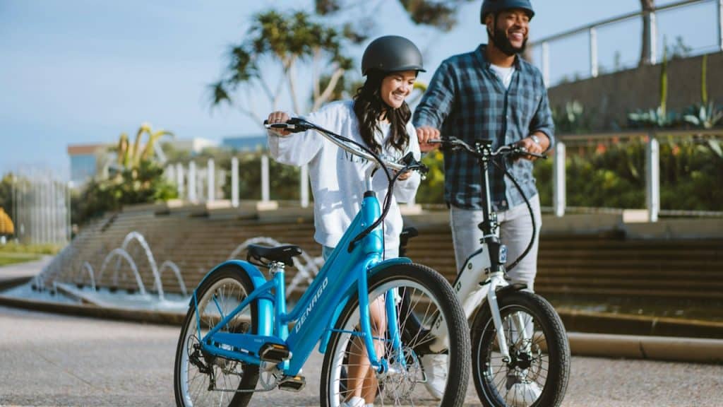 A man and a woman riding bikes.