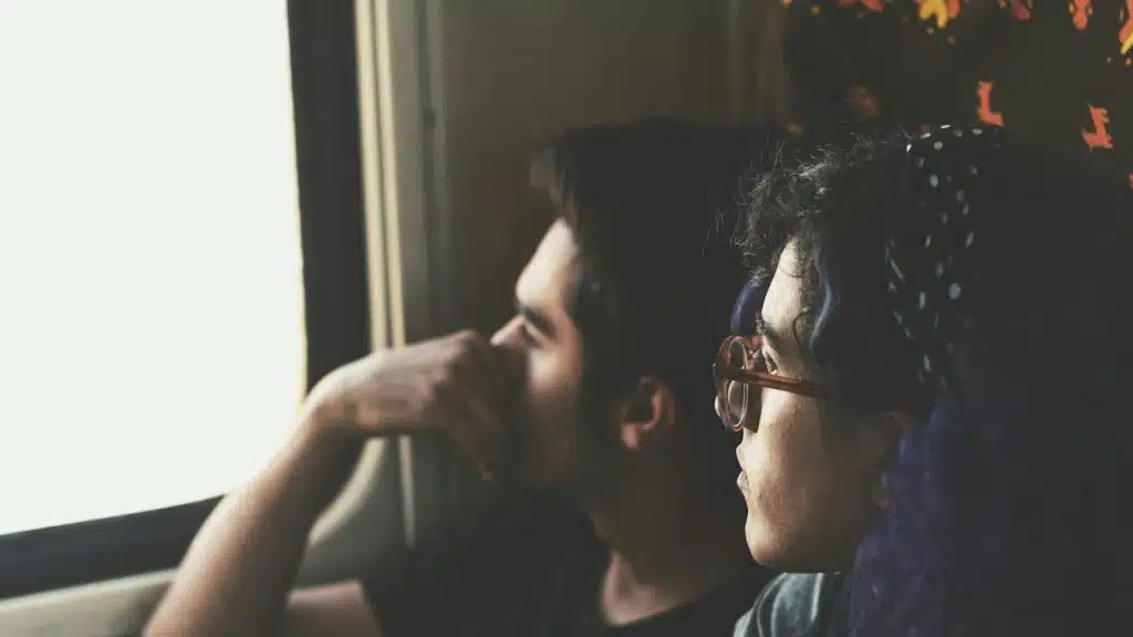 A couple in deep conversation looking out of the window.