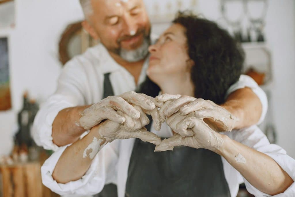 A man and woman in pottery class