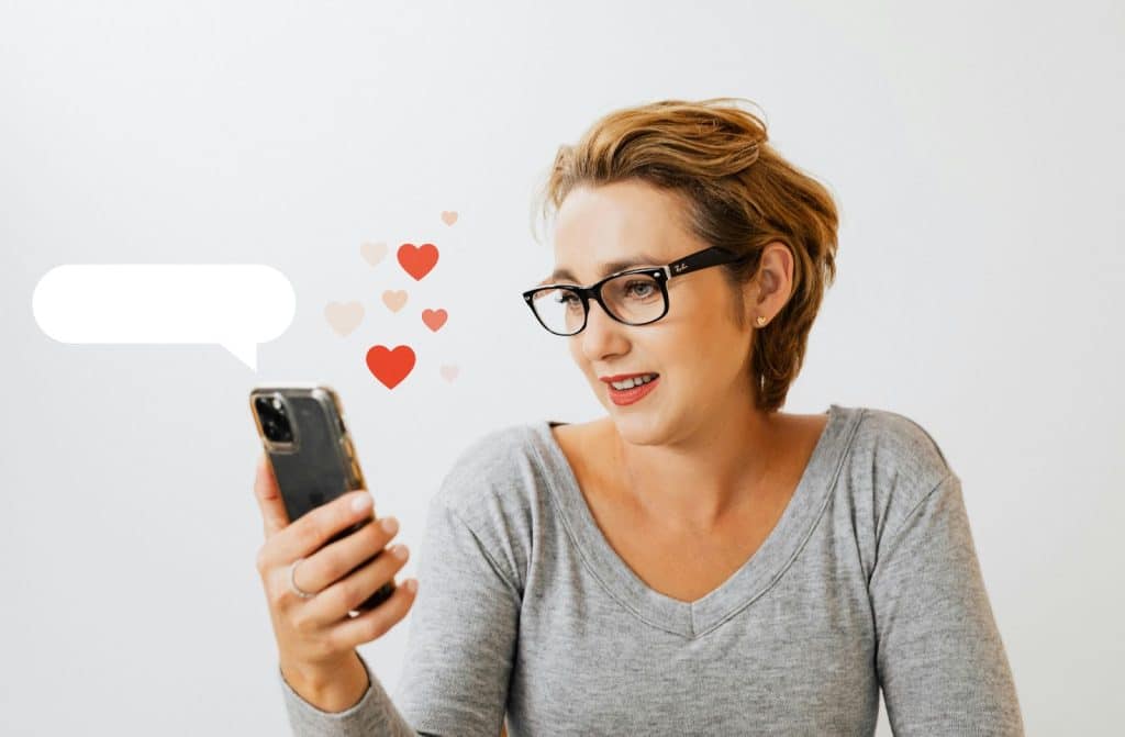 A woman reading something to her phone