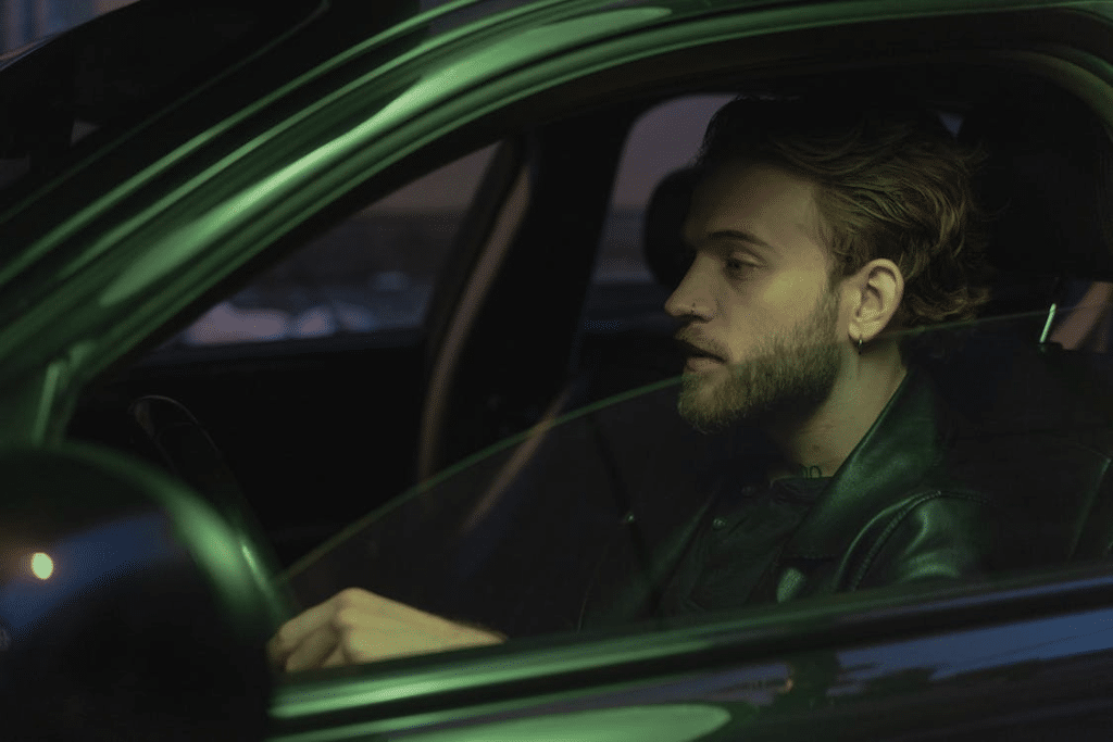 Man in Black Jacket Driving Car