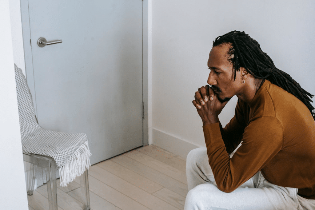 African American guy sitting in room