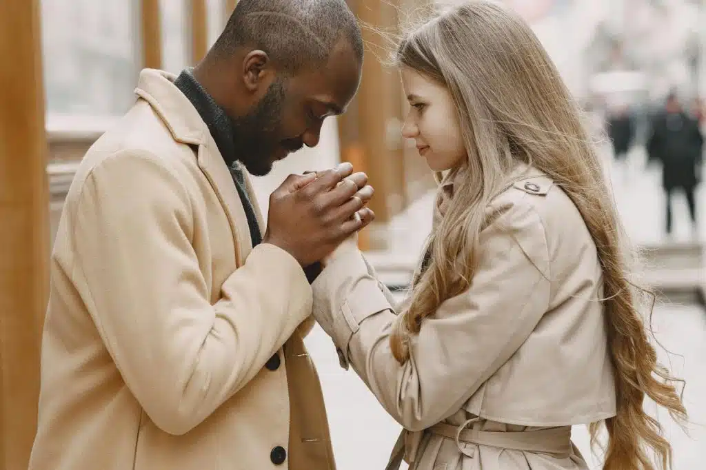 A man and woman holding hands together
