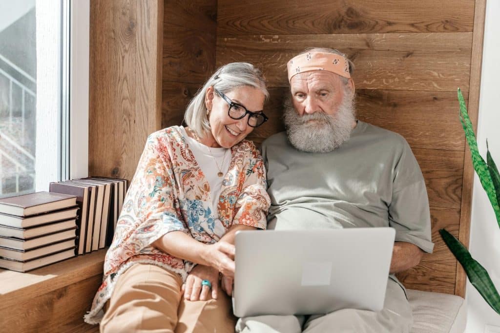 A man and woman together using a laptop