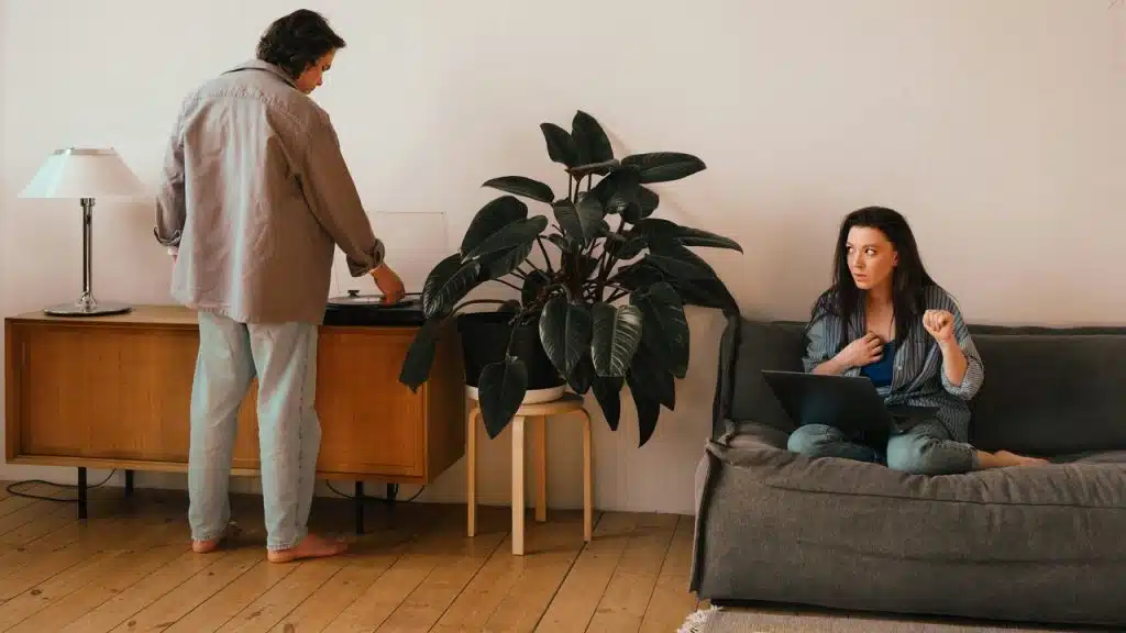 A couple ignoring each other in the living room