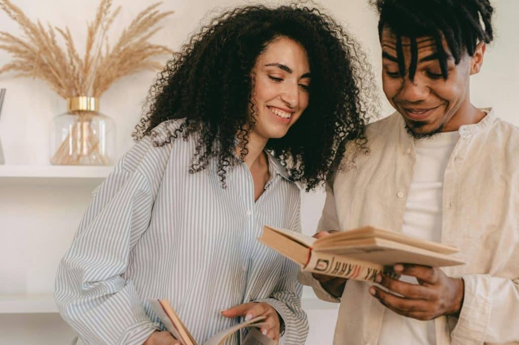 A man and woman looking at the book