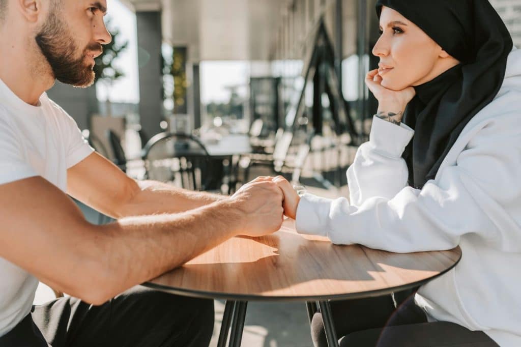 A man holding a woman’s hands